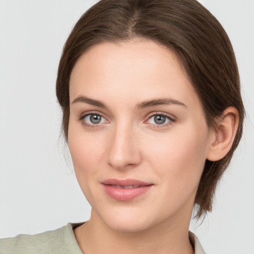 Joyful white young-adult female with medium  brown hair and grey eyes