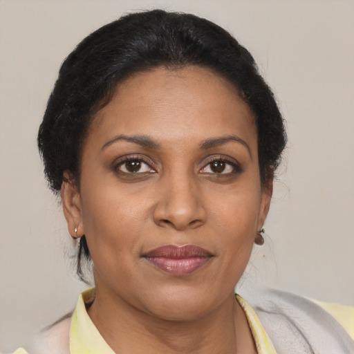 Joyful black adult female with short  brown hair and brown eyes