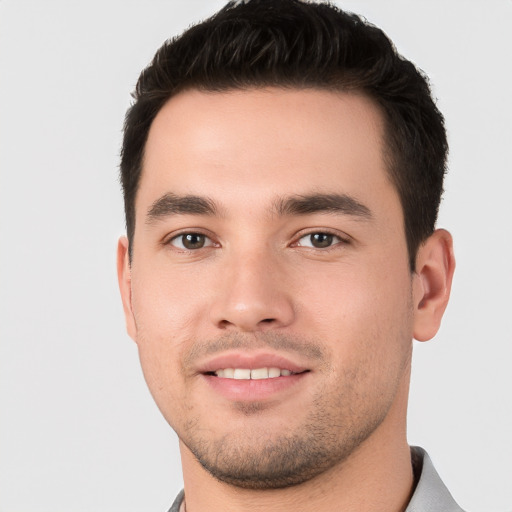 Joyful white young-adult male with short  black hair and brown eyes