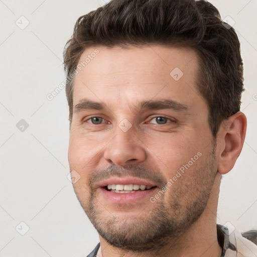 Joyful white young-adult male with short  brown hair and brown eyes