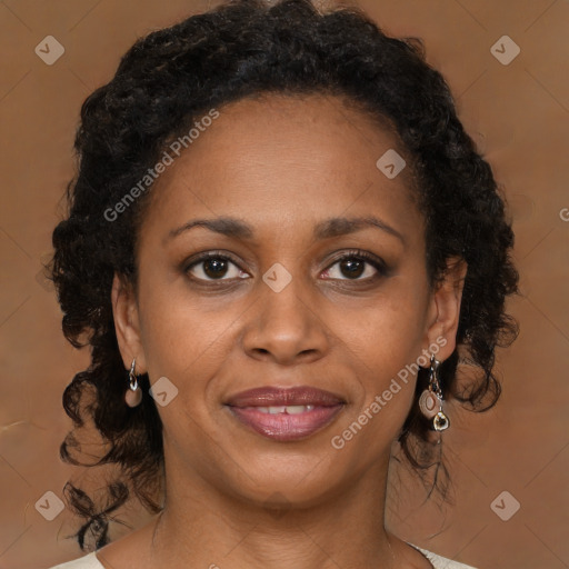 Joyful black adult female with medium  brown hair and brown eyes