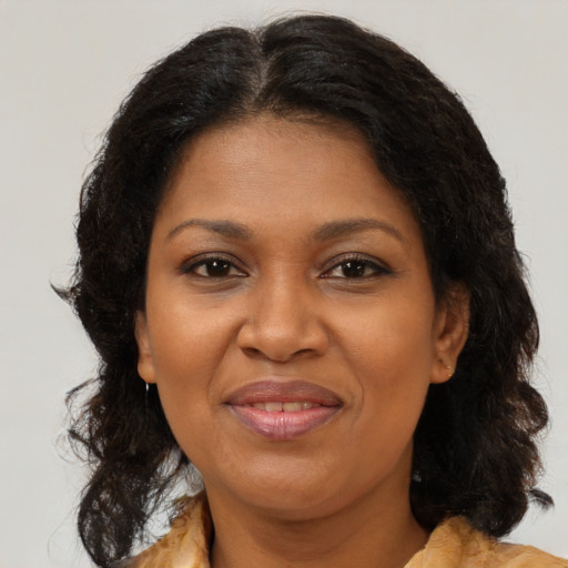 Joyful black adult female with medium  brown hair and brown eyes