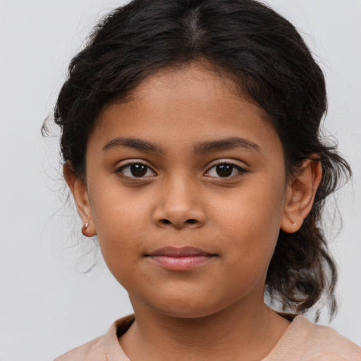 Joyful latino child female with medium  brown hair and brown eyes