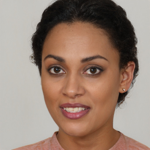Joyful black young-adult female with short  brown hair and brown eyes