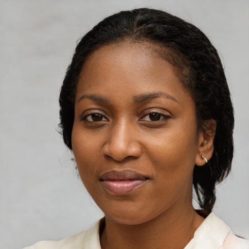 Joyful black young-adult female with medium  black hair and brown eyes