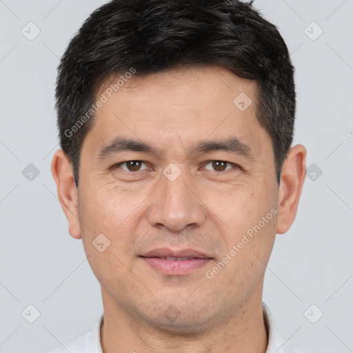 Joyful white adult male with short  brown hair and brown eyes