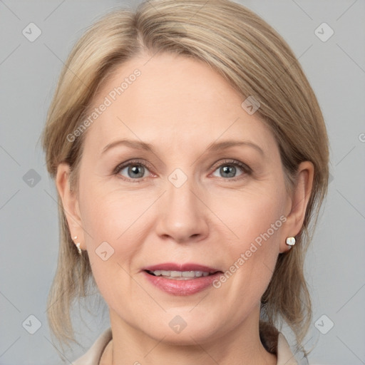 Joyful white adult female with medium  brown hair and grey eyes