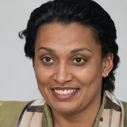 Joyful latino adult female with short  brown hair and brown eyes