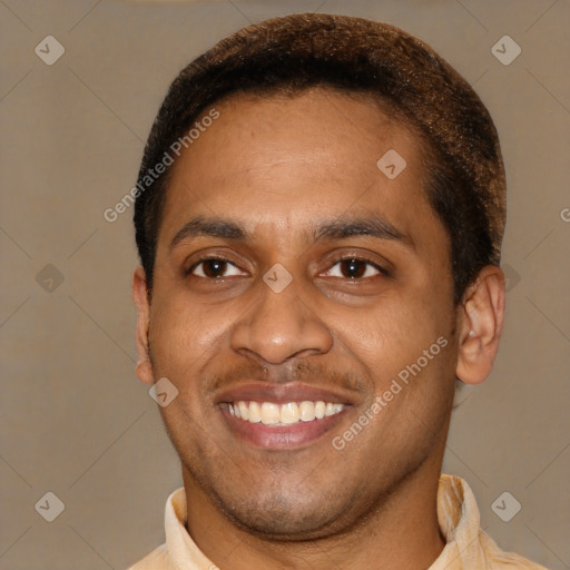 Joyful latino young-adult male with short  brown hair and brown eyes