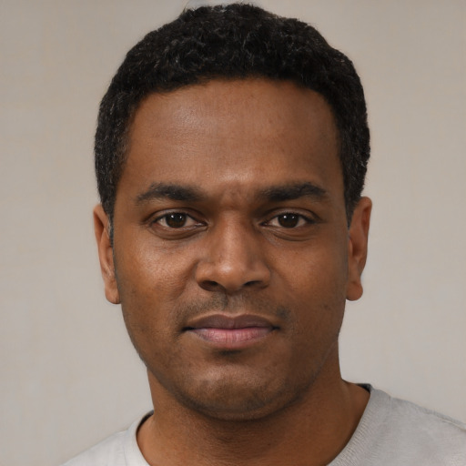 Neutral black young-adult male with short  black hair and brown eyes