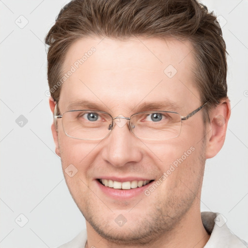 Joyful white adult male with short  brown hair and grey eyes