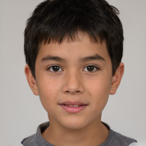 Joyful white child male with short  brown hair and brown eyes