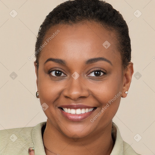 Joyful black young-adult female with short  brown hair and brown eyes