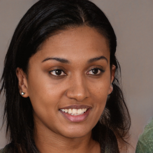 Joyful black young-adult female with long  brown hair and brown eyes