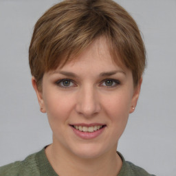 Joyful white young-adult female with short  brown hair and grey eyes