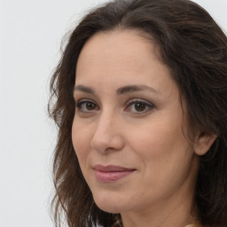 Joyful white adult female with long  brown hair and brown eyes