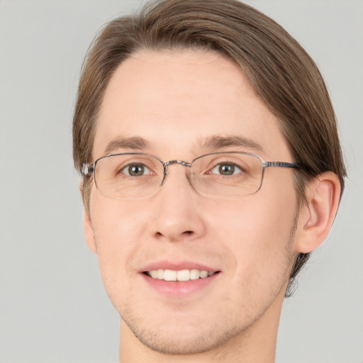 Joyful white adult male with short  brown hair and green eyes