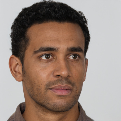 Neutral black young-adult male with short  black hair and brown eyes