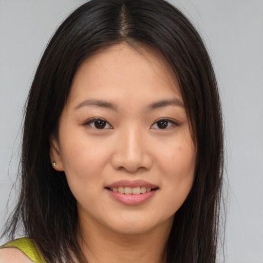 Joyful asian young-adult female with long  brown hair and brown eyes