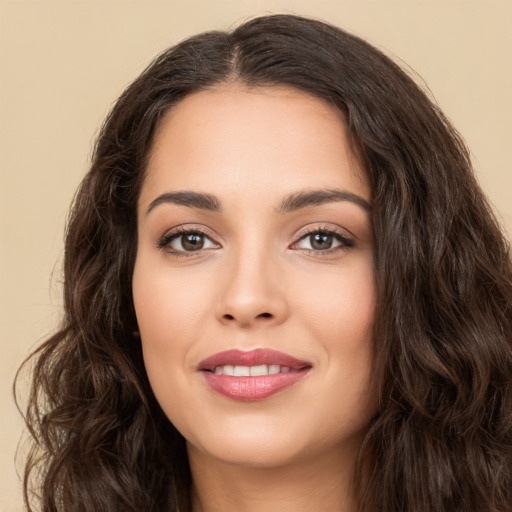 Joyful white young-adult female with long  brown hair and brown eyes