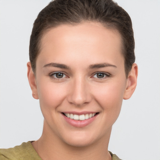 Joyful white young-adult female with short  brown hair and brown eyes