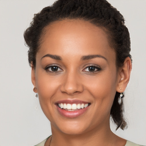 Joyful latino young-adult female with long  brown hair and brown eyes