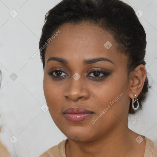 Joyful black young-adult female with long  black hair and brown eyes