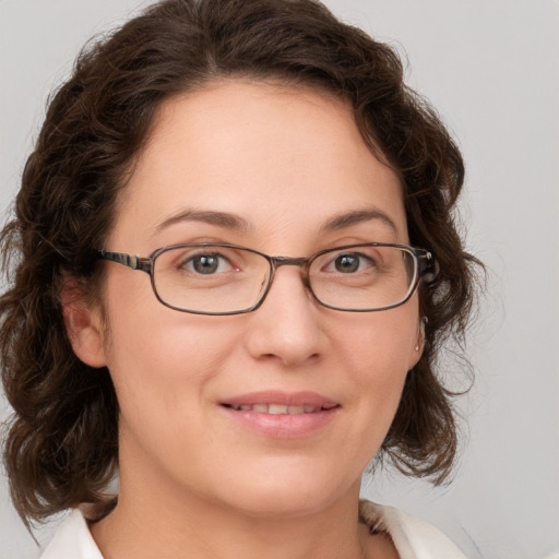 Joyful white young-adult female with medium  brown hair and green eyes