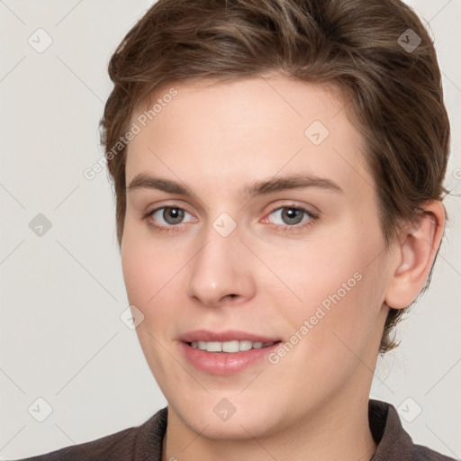 Joyful white young-adult female with short  brown hair and grey eyes