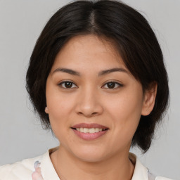 Joyful latino young-adult female with medium  brown hair and brown eyes