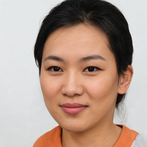 Joyful asian young-adult female with medium  brown hair and brown eyes