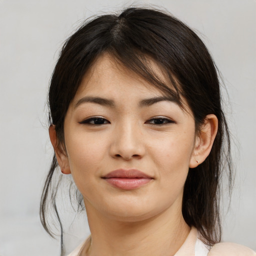 Joyful asian young-adult female with medium  brown hair and brown eyes