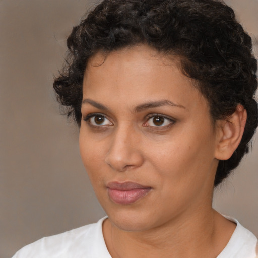 Joyful latino young-adult female with short  brown hair and brown eyes