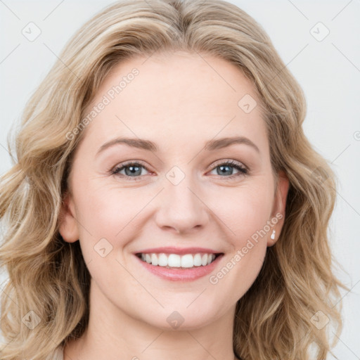 Joyful white young-adult female with long  brown hair and blue eyes