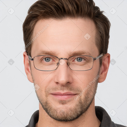 Joyful white young-adult male with short  brown hair and grey eyes