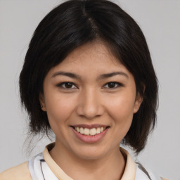 Joyful white young-adult female with medium  brown hair and brown eyes