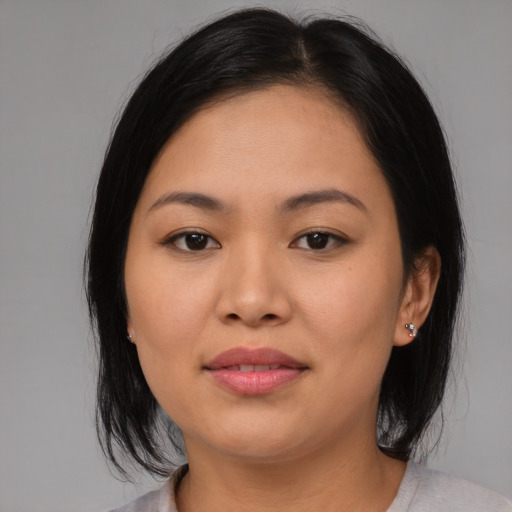 Joyful asian young-adult female with medium  brown hair and brown eyes