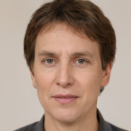 Joyful white adult male with short  brown hair and grey eyes