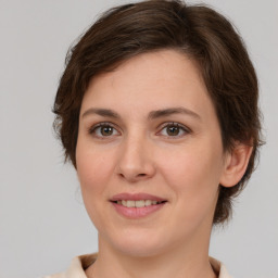 Joyful white young-adult female with medium  brown hair and green eyes