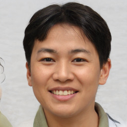 Joyful asian young-adult male with short  brown hair and brown eyes