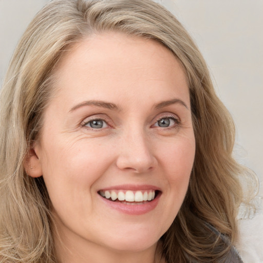 Joyful white young-adult female with long  brown hair and blue eyes