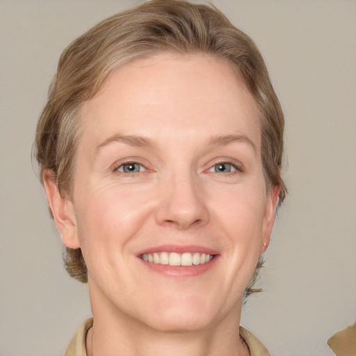 Joyful white adult female with medium  brown hair and grey eyes