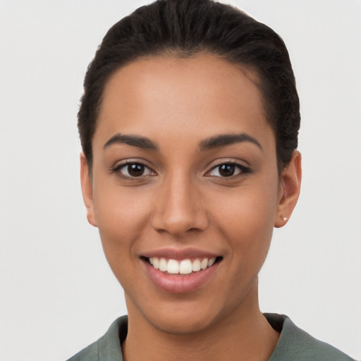 Joyful latino young-adult female with short  brown hair and brown eyes