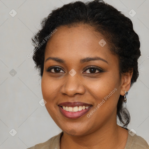 Joyful black young-adult female with short  brown hair and brown eyes