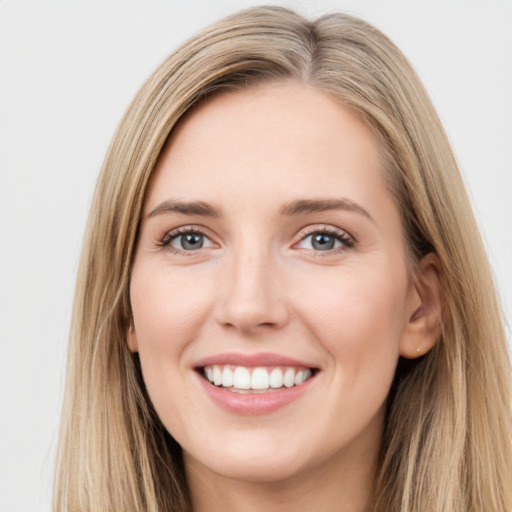 Joyful white young-adult female with long  brown hair and green eyes