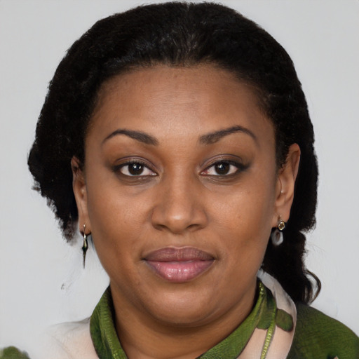 Joyful black adult female with short  brown hair and brown eyes