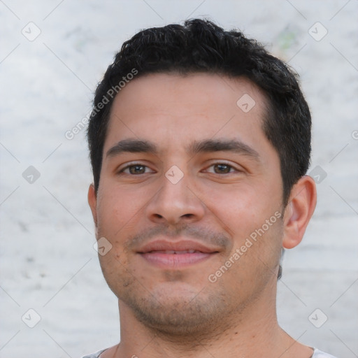 Joyful white young-adult male with short  black hair and brown eyes