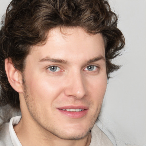 Joyful white young-adult male with medium  brown hair and brown eyes