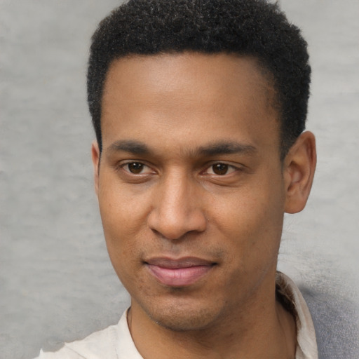 Joyful latino young-adult male with short  brown hair and brown eyes