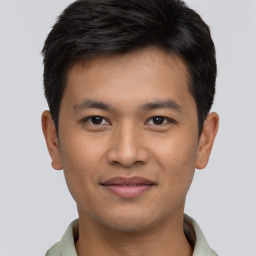 Joyful asian young-adult male with short  brown hair and brown eyes